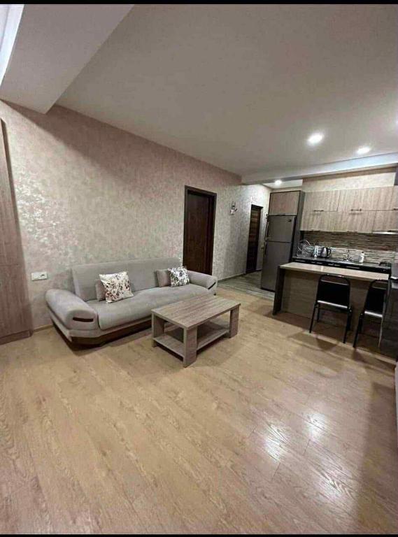 a living room with a couch and a coffee table at bakuriani in Itʼkhvisi
