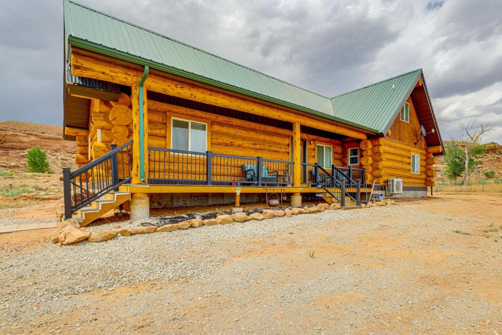 a large wooden cabin with a green roof at Explore Uintah Basin Rustic Cliff Cabin with Loft in Fort Duchesne