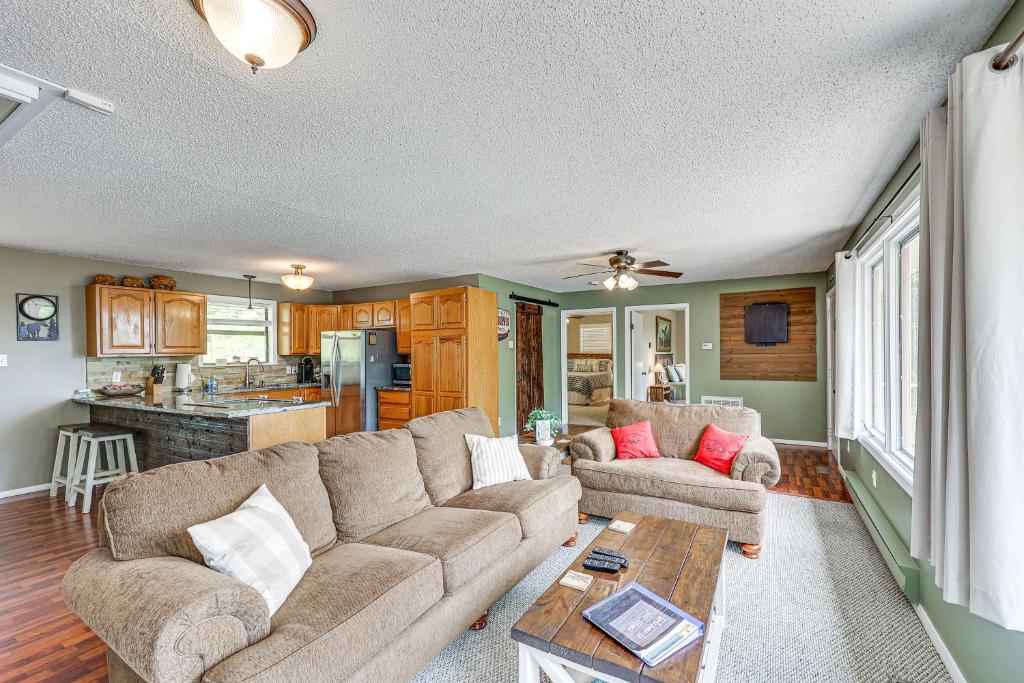 a living room with a couch and a table at Treetop Hideaway with Lake Views and Fire Pit! in Fairfield Bay