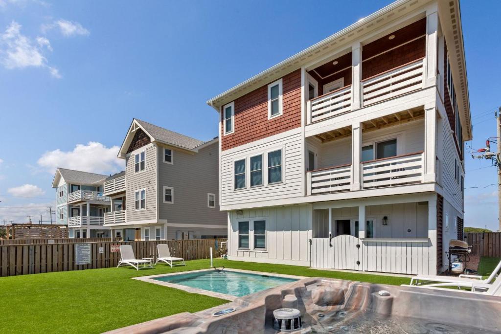 un immeuble d'appartements avec une piscine devant dans l'établissement 4052 - Endless Summer, à Kitty Hawk Beach