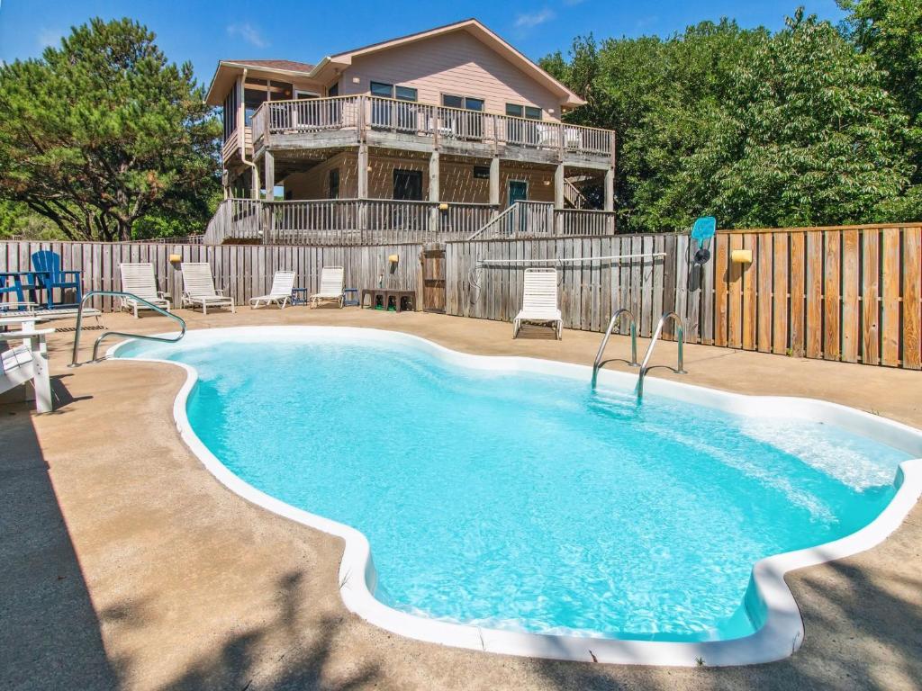 a swimming pool in front of a house at 3041 - The Beach House in Southern Shores