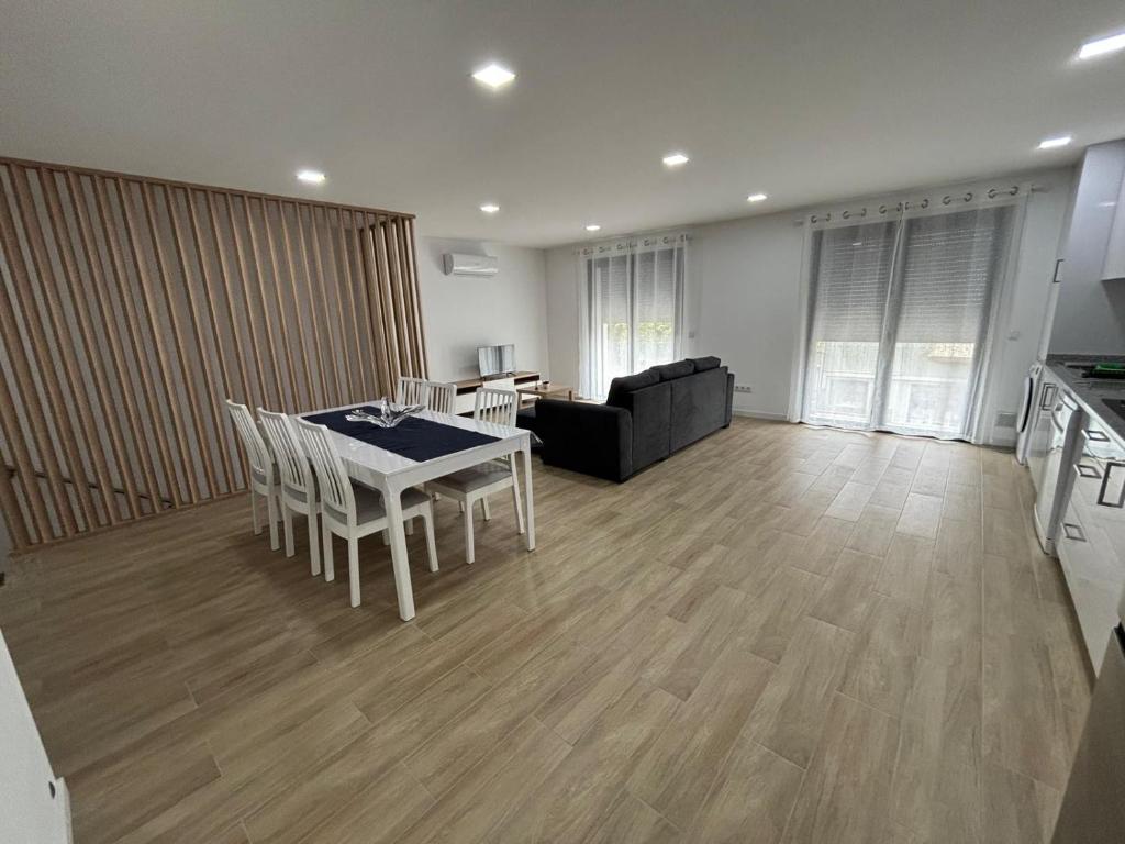 a living room with a table and a couch at Alojamento Alto da Lixa in Freixo de Cima