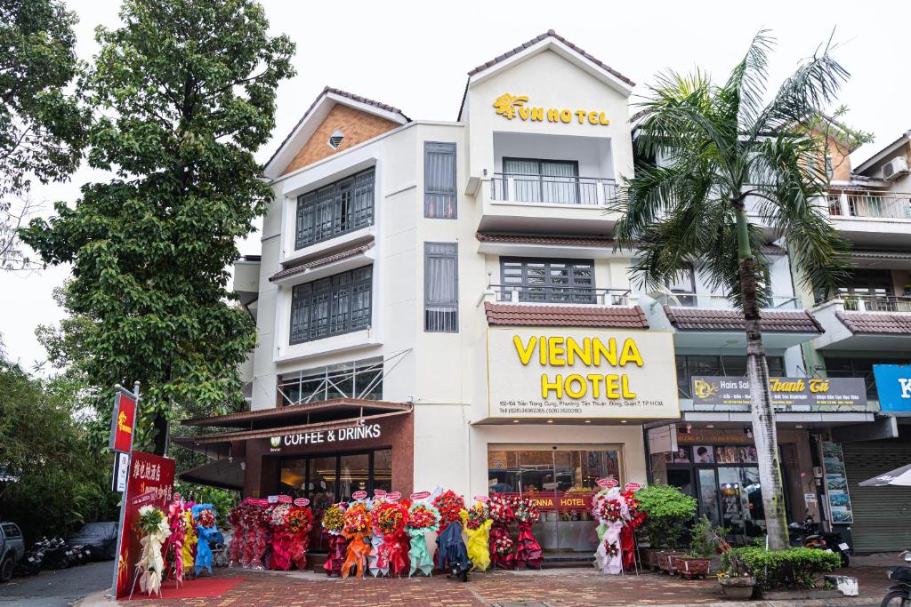 a group of people standing outside of a hotel at Vienna Hotel in Ho Chi Minh City