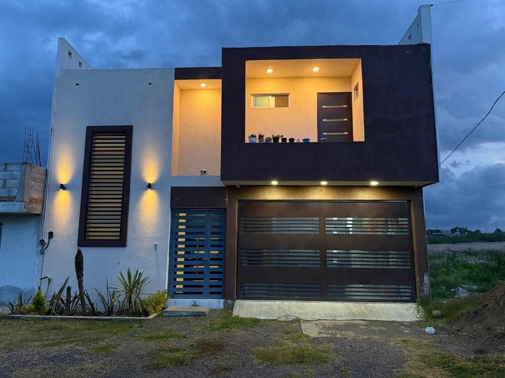 a house with a garage door in front of it at Villa los Encinos 