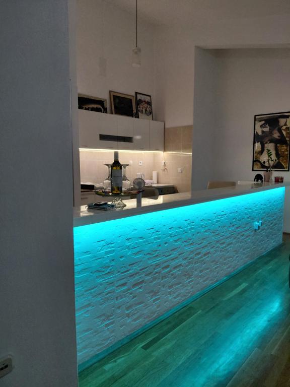 a kitchen with a swimming pool in the middle of a room at Apartments Galery in Makarska