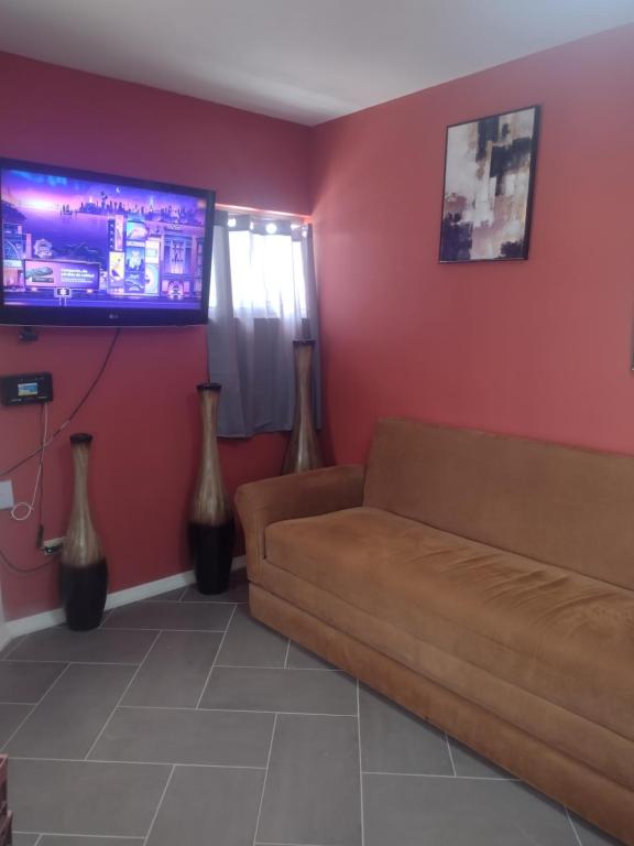 a living room with a couch and a flat screen tv at Céntrico y accesible in Ciudad Juárez