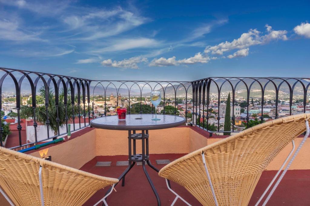 a balcony with a table and two chairs at Casa Mayahuel in Oaxaca City