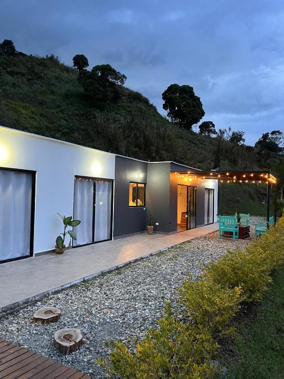 a house with a patio and a green bench at Villa Amore in El Peñol