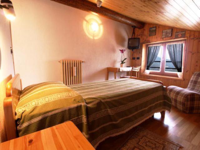 Postel nebo postele na pokoji v ubytování Hotel Alpe Fleurie