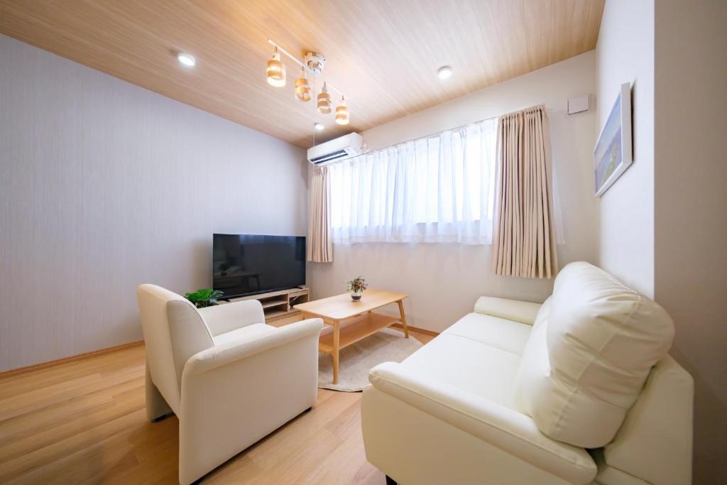 a living room with white furniture and a television at BLUESOLARE Reef - Vacation STAY 14140v in Miyako Island