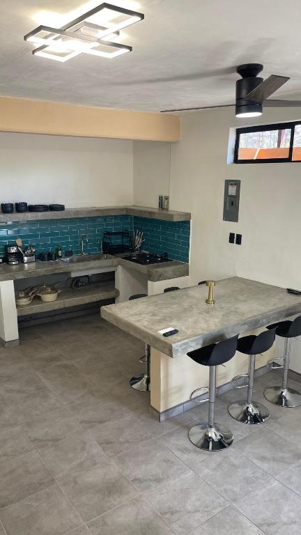 a large kitchen with a table and some chairs at Casa Marlin in Mulegé