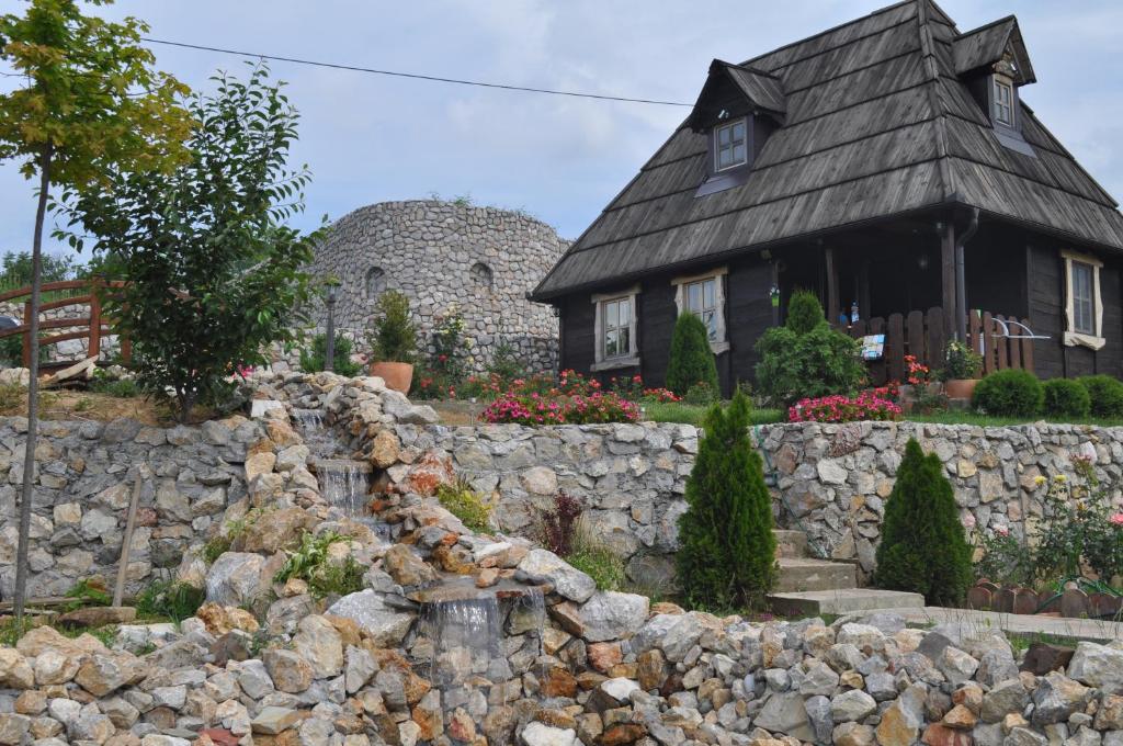 a stone wall in front of a house at Etno Apartment Vrdnik in Vrdnik