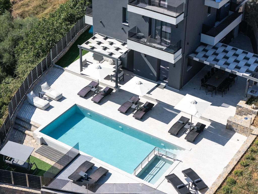 an aerial view of a house with a swimming pool at Heliodora Villa, Premium Nature Living, By ThinkVilla in Áyios Mámas
