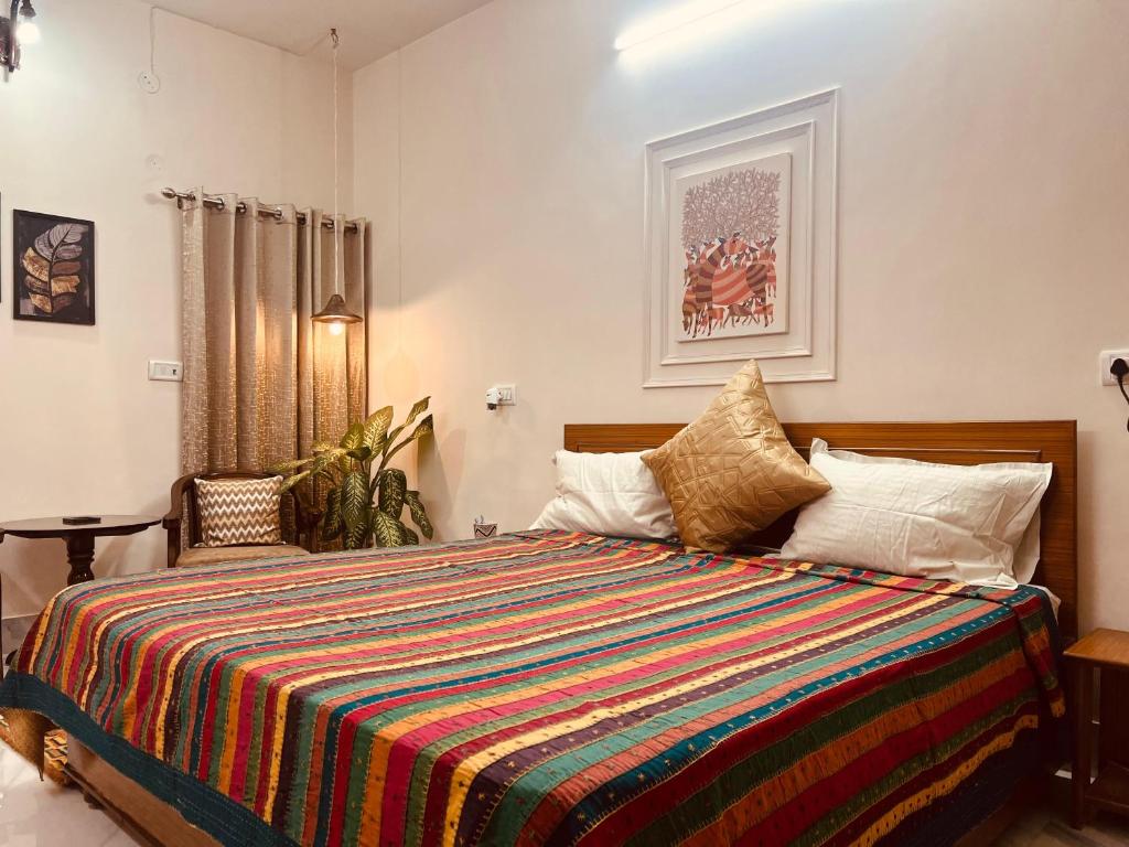 a bedroom with a large bed with a colorful blanket at Matrika Homestay in Lucknow