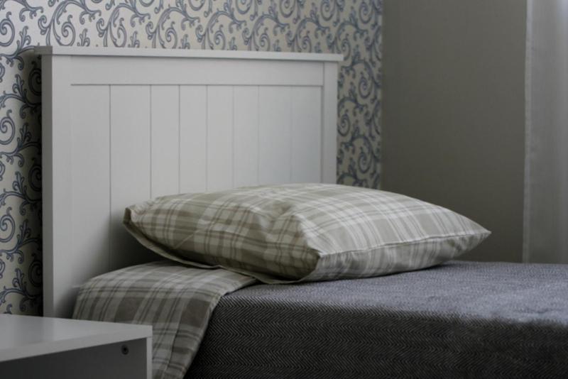 a pillow sitting on top of a bed in a bedroom at Liisu Külalistemaja in Haapsalu