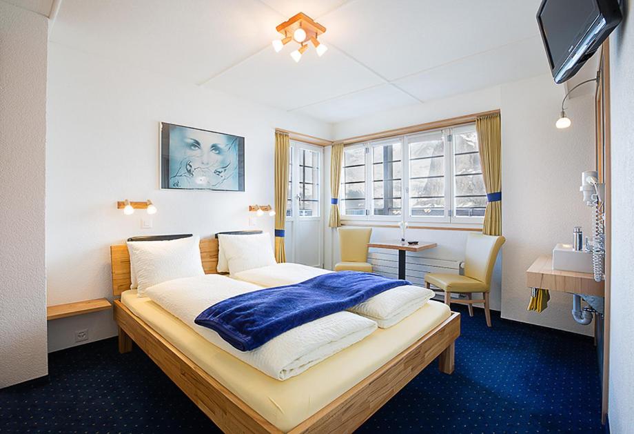 Postel nebo postele na pokoji v ubytování Hotel Alpina