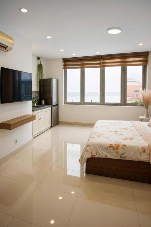 a large bedroom with a bed and a large window at Peaceful Paradise Homestay in Hai Phong