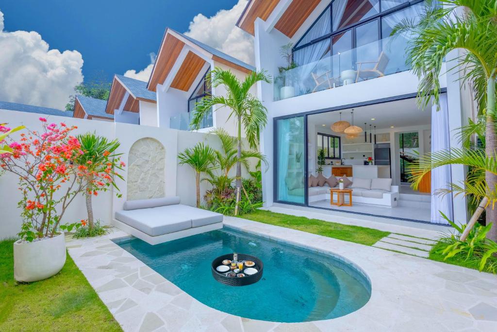 an exterior view of a house with a swimming pool at Villa Kanu in Uluwatu