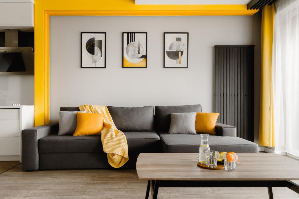 a living room with a couch and a coffee table at Prestige Apartaments 79 in Wrocław
