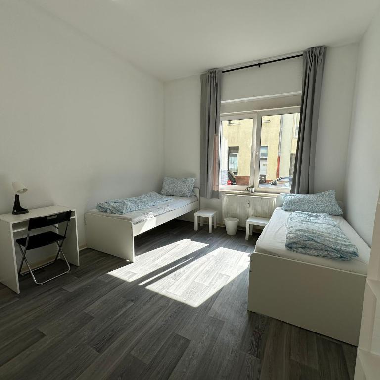 a bedroom with two beds and a window at WDI - WokersDream in Krefeld