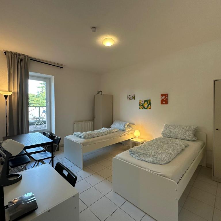 a living room with two beds and a table at WDI - WorkersDream 2 in Krefeld
