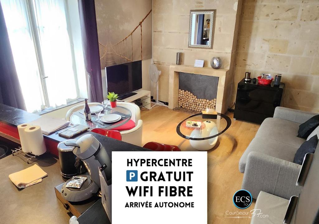 a living room with a couch and a table at "L'Appart" Vieux Tours - Charme - Place Plumereau - Arrivée Autonome in Tours