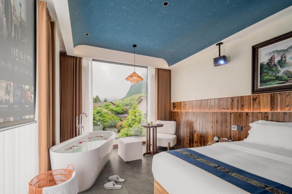a hotel room with a tub and a bed at Plum-Spring Elegant Lodge in Zhangjiajie