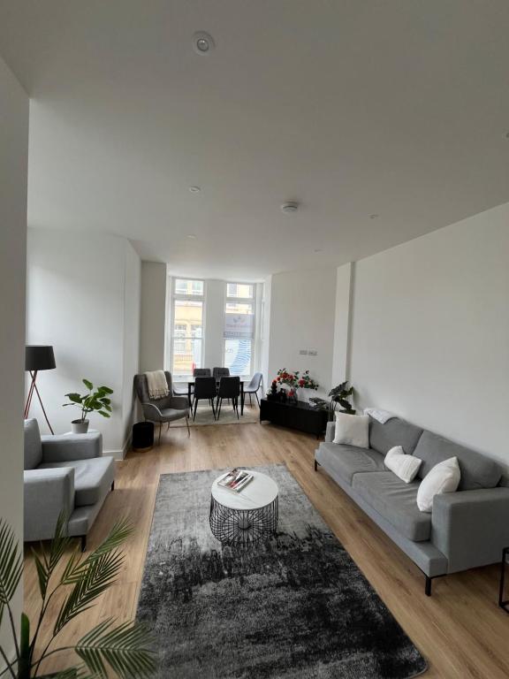 a living room with a couch and a table at Margate Apartment by The Sea 5 minutes to beach and dreamland in Margate