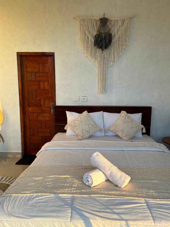 a bedroom with a bed with two towels on it at Tera glamping bali 2 in Baturaja