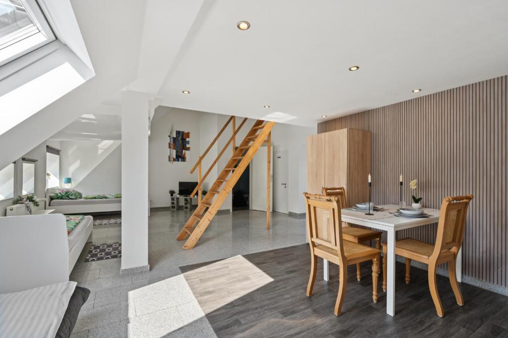 a dining room with a table and chairs and a staircase at Monteur Wohnung Kleve KL05 - Innenstadt in Kleve
