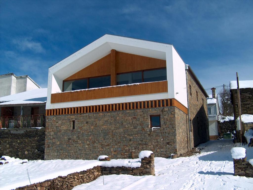 a building with snow on the ground in front of it at Casa Luís Gonzaga in Bragança
