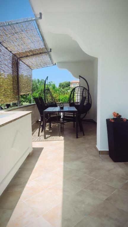 a dining room with a table and two chairs at House Solis in Banjol