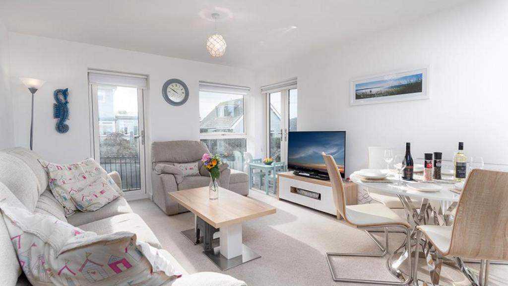 a living room with a couch and a table at Seahorses in Conwy
