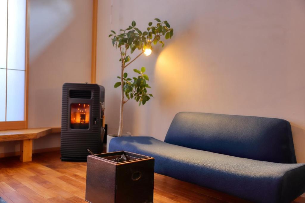 a blue chair in a living room with a fire place at Kazekuru - Vacation STAY 18924 in Fujiyoshida
