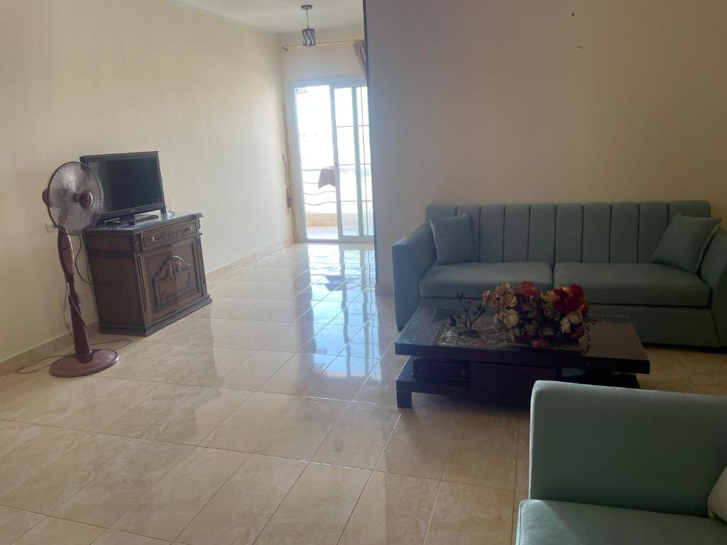 a living room with a couch and a table at Elhlal luxury apartment in Hurghada