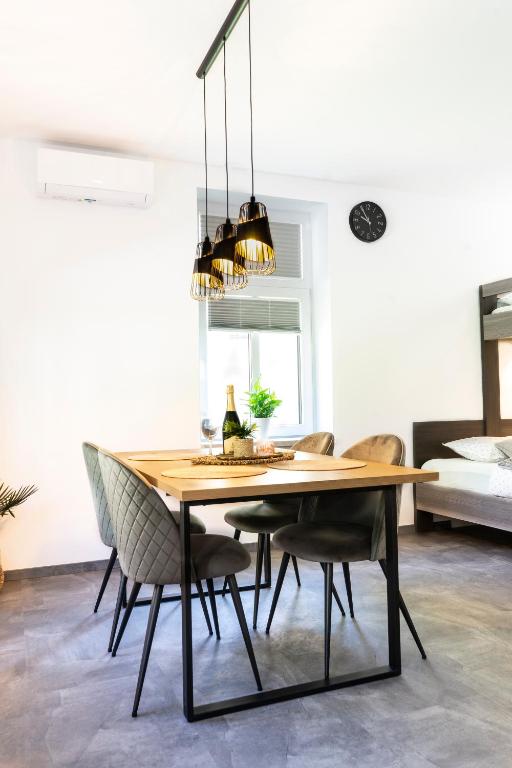 a dining room with a wooden table and chairs at Apartmaji na Pošti in Podsreda