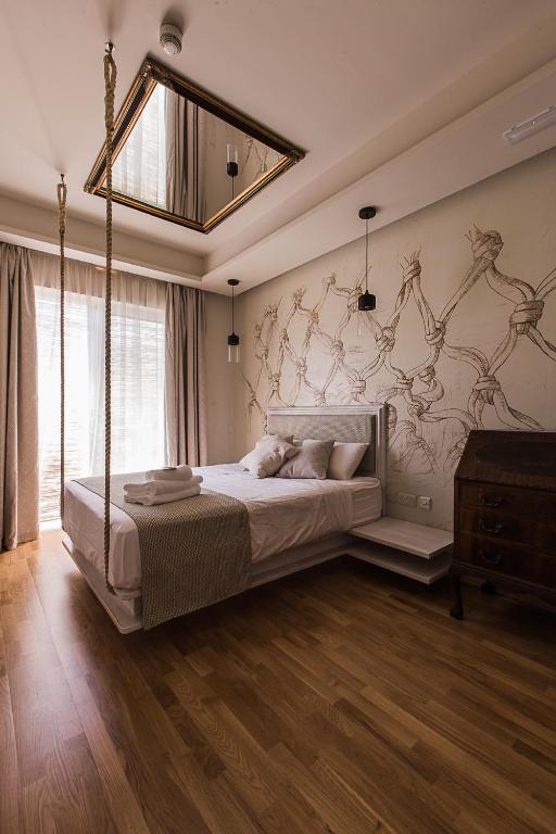 a bedroom with a large bed with a wall mural at Murella Living in Marsalforn