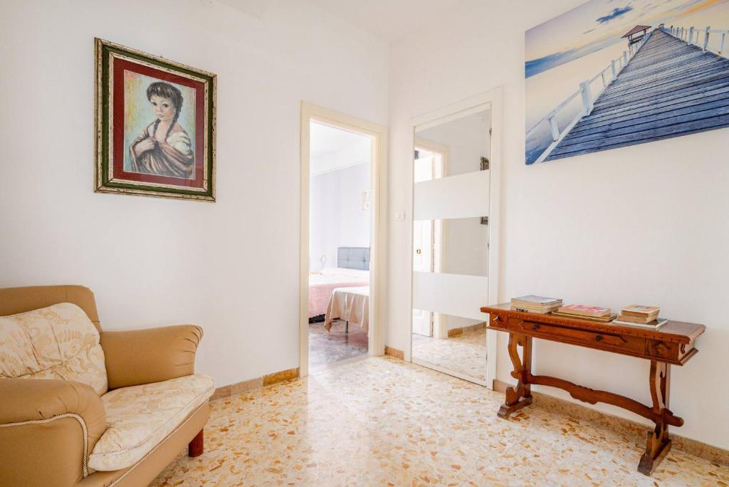 a living room with a couch and a table at 2 Suite a due passi dal Mare, Wi-Fi e Natura in Pescara