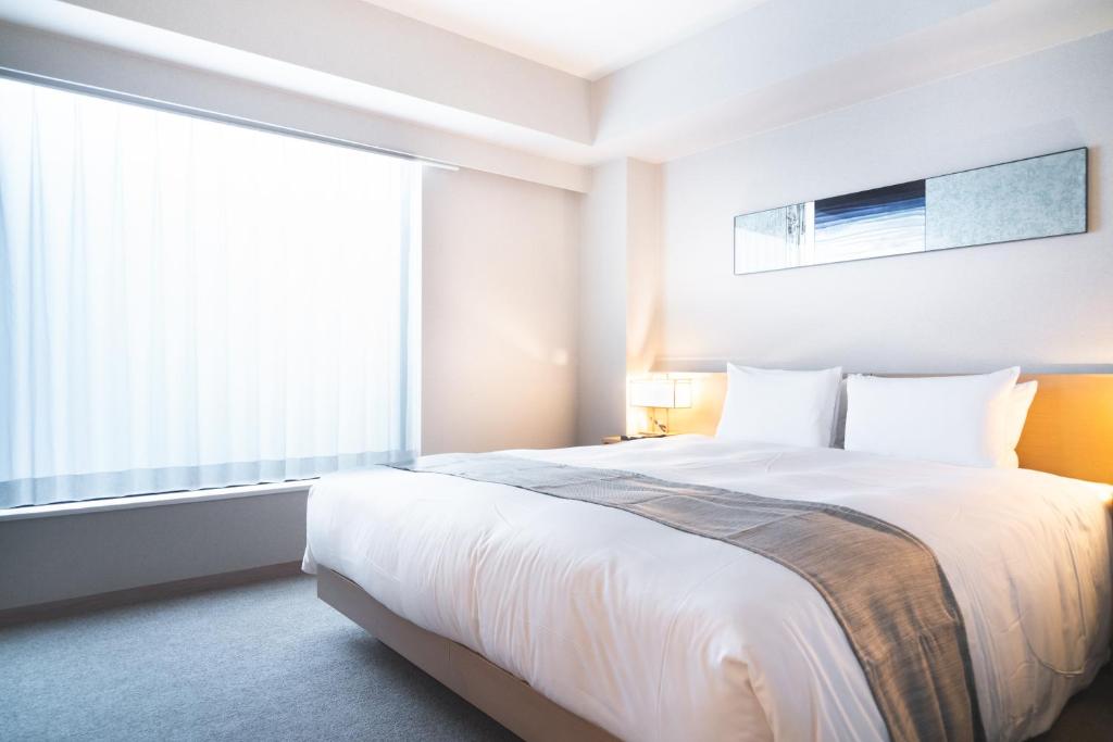 Postel nebo postele na pokoji v ubytování KIORI Hotel Takakura