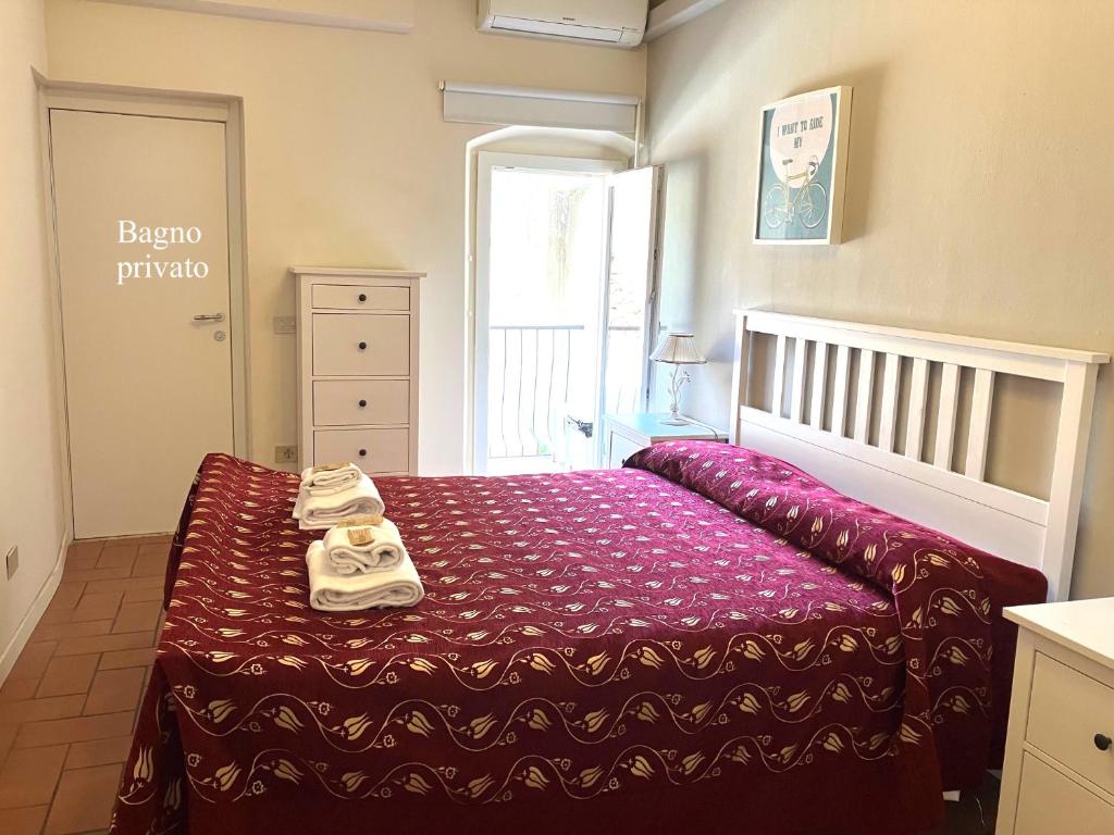 a bedroom with a bed with towels on it at San Frediano 56 in Florence