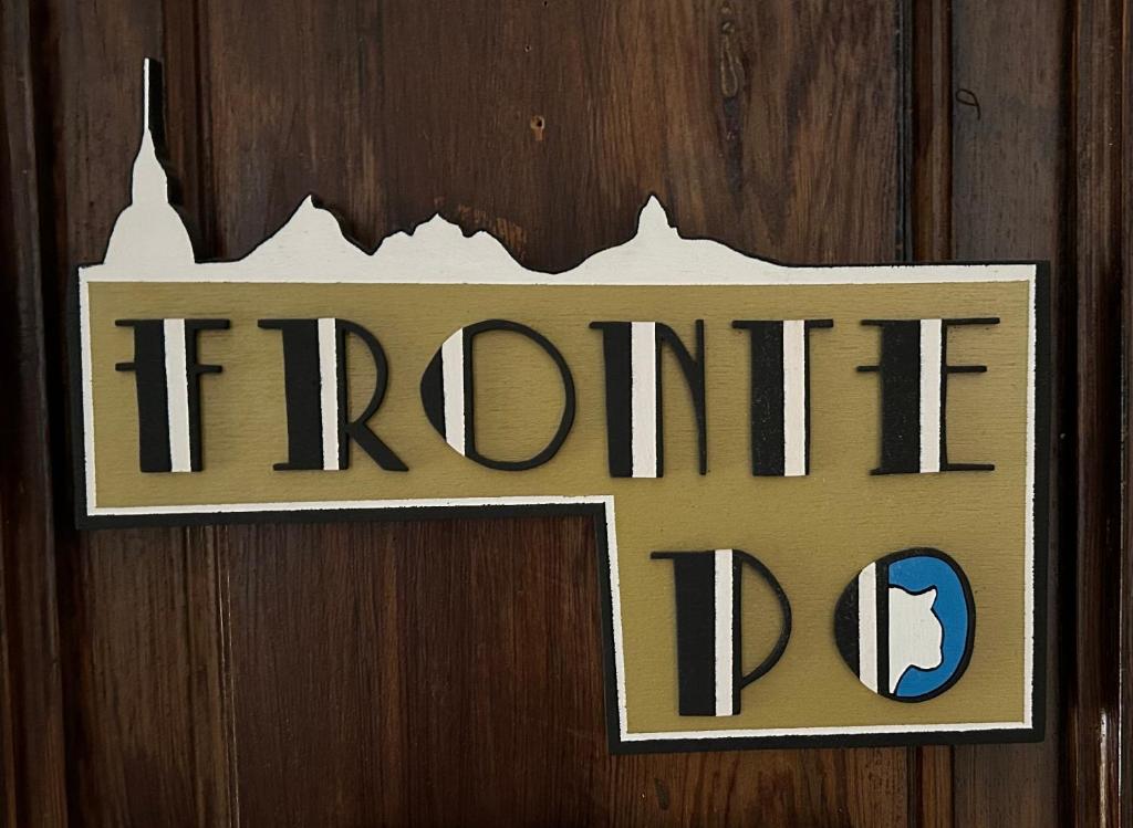a sign on a wooden door with the words fire department at FRONTE PO in Turin