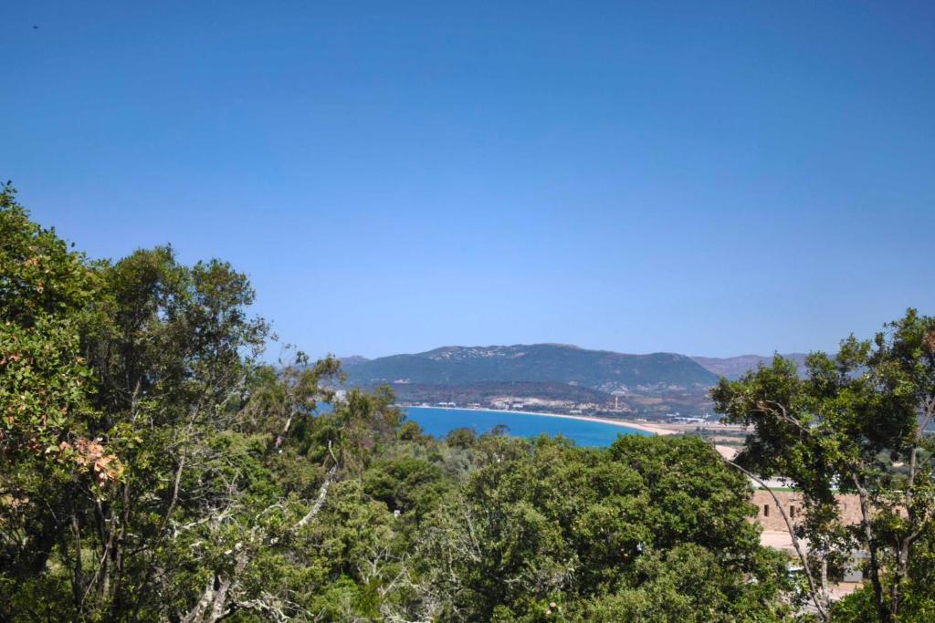 a view of a lake from the top of a hill at Family house with garden near the sea in Porticcio