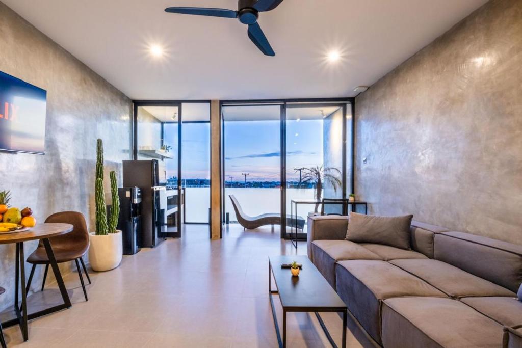 a living room with a couch and a table at Brand new apartment with stunning sunset views in Munggu
