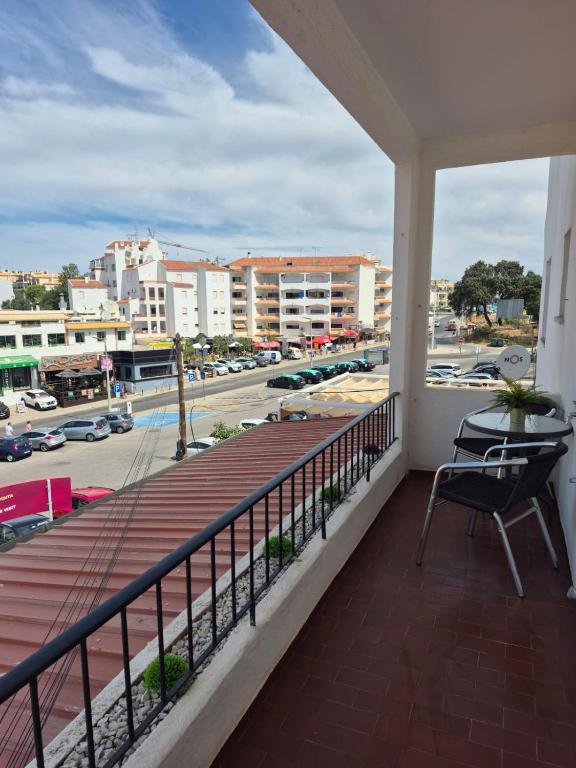 a balcony with a table and a view of a city at Costa Mar by Albufeira Rental in Olhos de Água