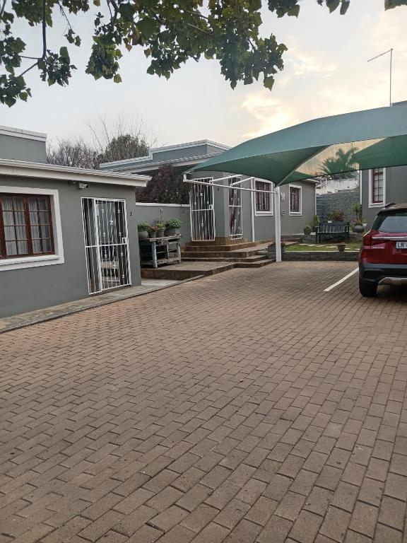 a house with a car parked in front of it at Fancy Pansy in Germiston