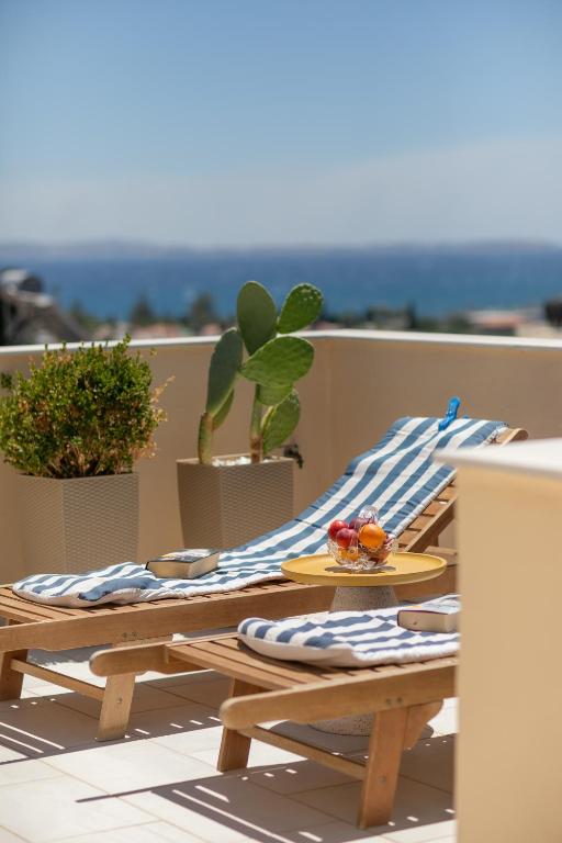 two picnic tables with towels and a plate of fruit at ISLAND Time Deluxe Apartment Downtown 3 floors in Chios