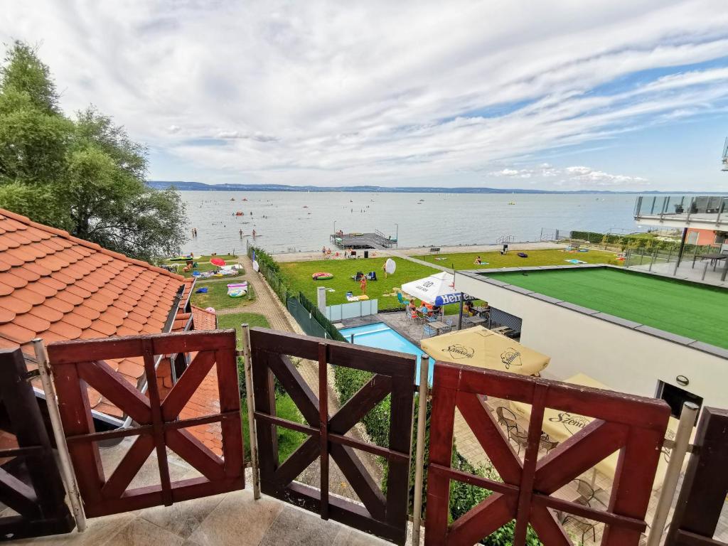 a view of the water from the balcony of a house at Napospart 32 in Balatonlelle