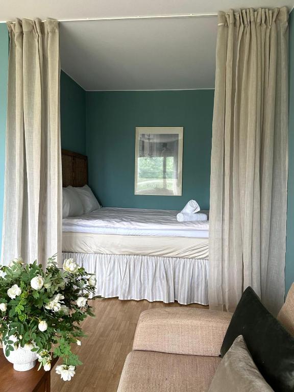 a bedroom with a bed in a room with blue walls at Mysiga 21 an in Mariehamn