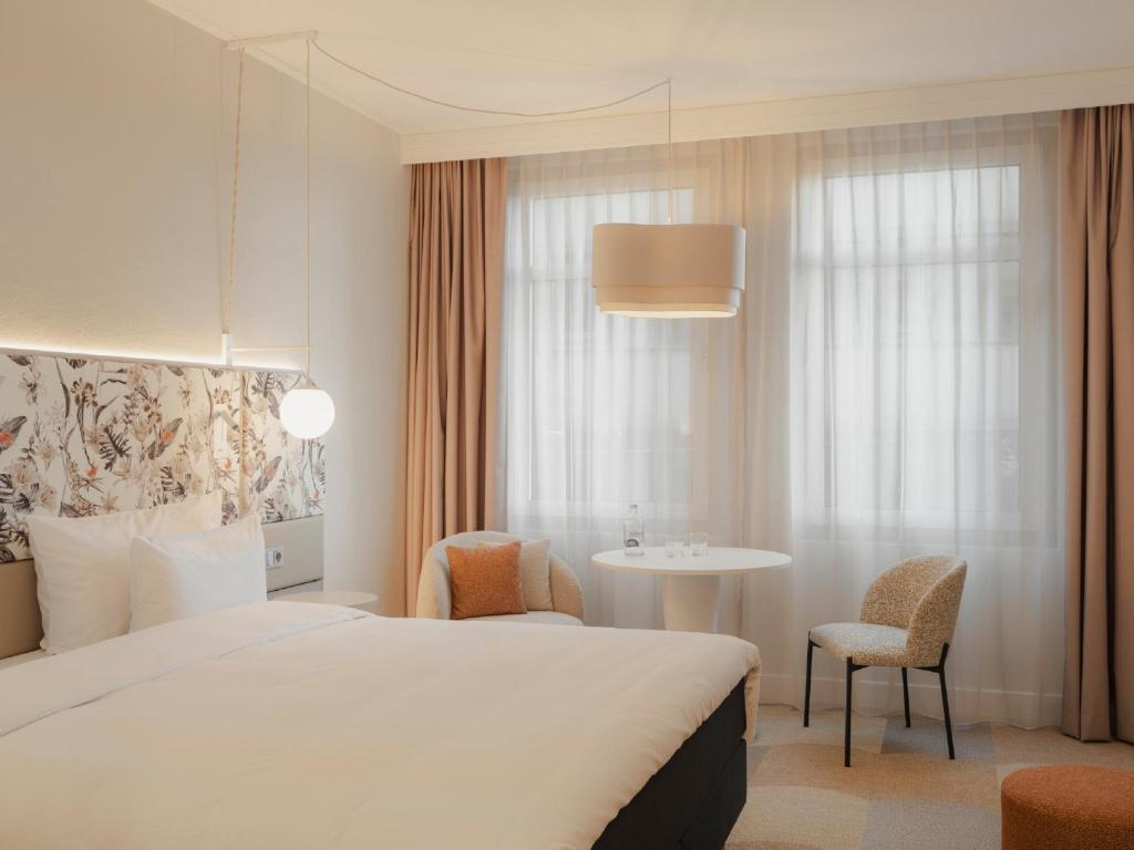 a hotel room with a bed and a table at Radisson Blu Hotel Bremen in Bremen