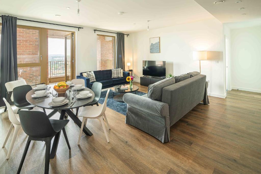 a living room with a couch and a table at Bermondsey Apartments By Sleepy Lodge in London
